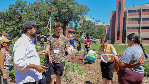 Dr. Gabriel Bruguier leads students in an activity on UNL campus.