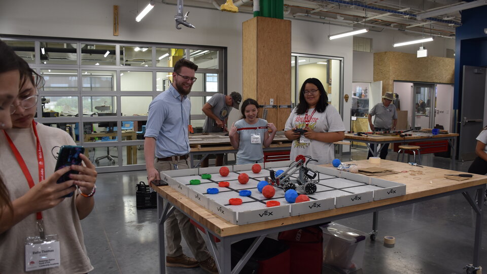 Students testing their modified robot in a race against time.